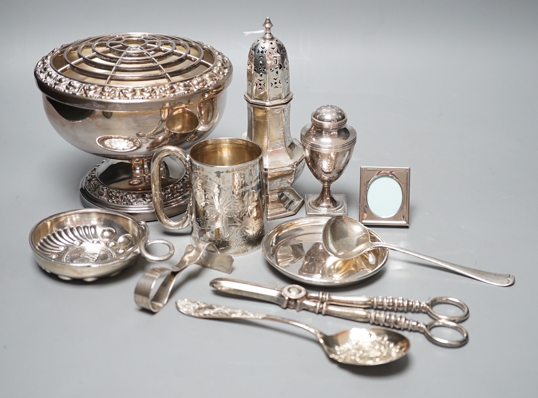 A George III silver vase shaped pepperette, Richard Evans? London, 1788, 88mm, a Victorian silver christening mug, a later silver sugar caster, a French white metal taste vin and other sundry silver and plated items.
